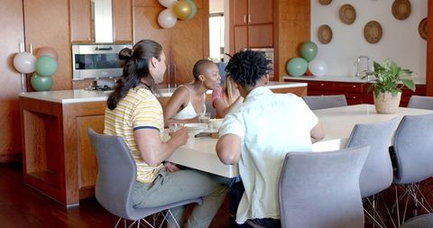 Friends Smiling Together in Modern Kitchen Gathering