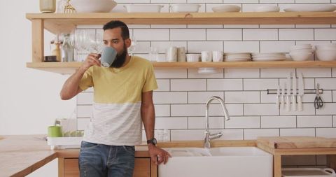 Man Relaxing in Modern Kitchen Drinking Tea Weekend