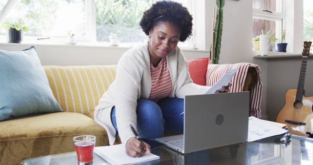 Young Woman Working from Home with Laptop and Documents - Download Free Stock Images Pikwizard.com