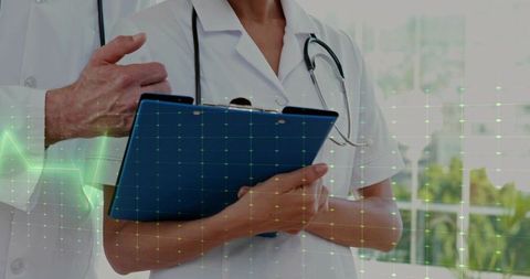 Clinicians Reviewing ECG Data on Clipboard with Stethoscope Showing Team Collaboration