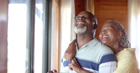 Joyful Senior African American Couple Hugging by Window - Download Free Stock Images Pikwizard.com