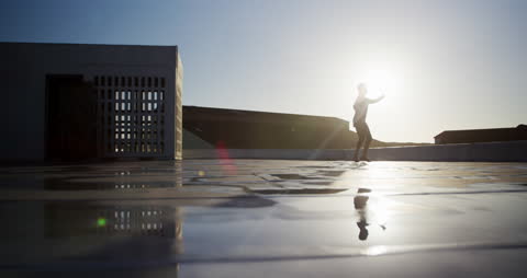 Ballet Dancer Performing on Rooftop at Sunrise