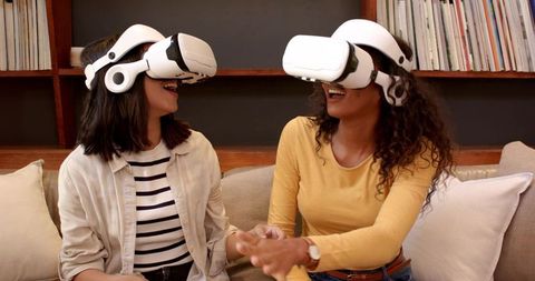Diverse Women Enjoying Virtual Reality with Headsets at Home