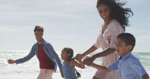 Happy Family Walking at Beach on Sunny Day