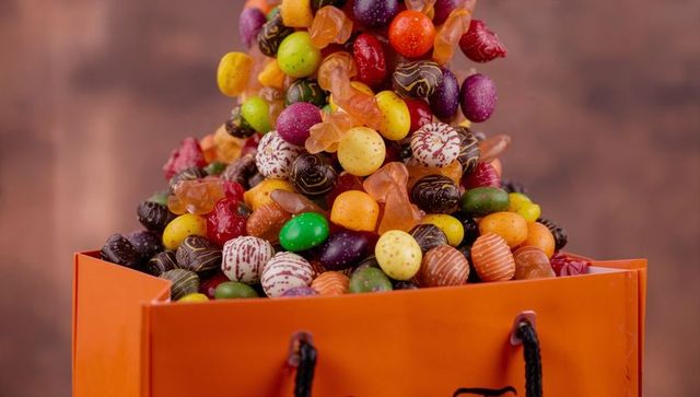 Overflowing orange bag filled with colorful candies