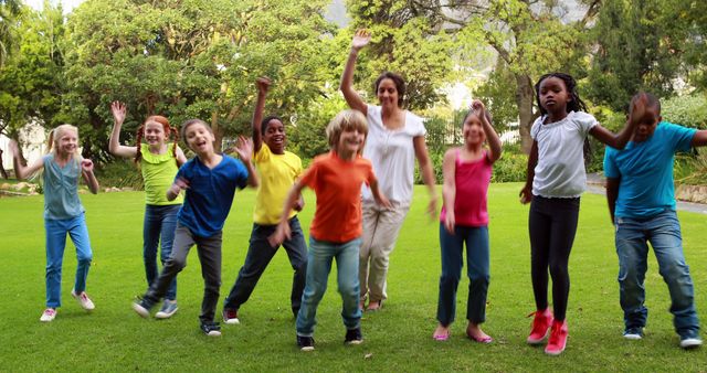 Diverse Group of Children Excitedly Jumping Together Outdoors - Download Free Stock Images Pikwizard.com