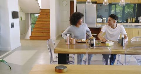 Friends Enjoy Breakfast and Coffee in Modern Kitchen