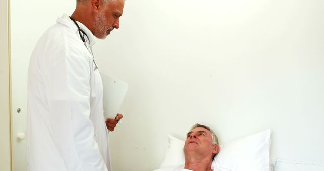 Doctor Diagnosing Senior Patient in Bed During Hospital Visit - Download Free Stock Images Pikwizard.com