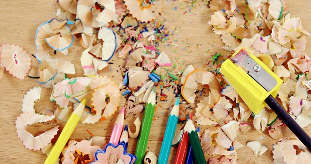 Color Pencils and Shavings Spread on Wooden Table - Download Free Stock Images Pikwizard.com