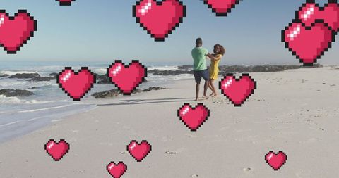 Couple Dancing on Beach with Digital Heart Icons Overlaid