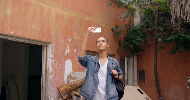 Young Man Taking Selfie Outdoors with Smartphone - Download Free Stock Images Pikwizard.com