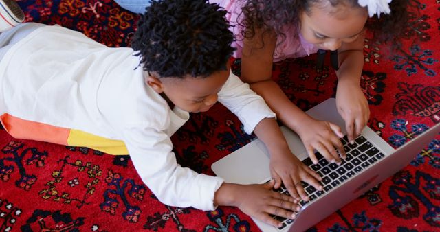 Children Lying on Carpet Using Laptop Together - Download Free Stock Images Pikwizard.com