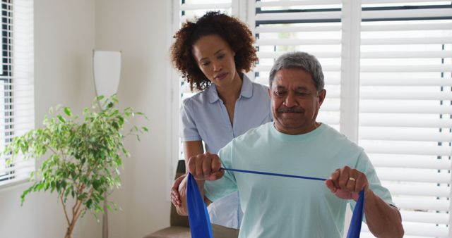 Senior Man Exercising with Physiotherapist Using Resistance Band - Download Free Stock Images Pikwizard.com