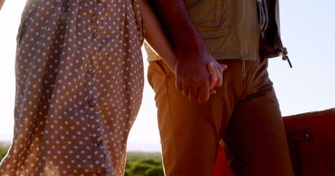 Middle-aged couple holding hands in outdoor setting