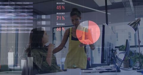 Women Collaborating in Modern Office with Data Visualization Overlay