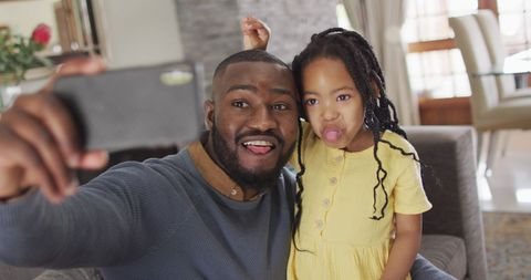 Dad and Daughter Enjoying Playful Selfie Moment at Home - Download Free Stock Images Pikwizard.com