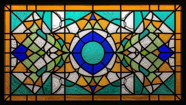 Vibrant stained glass window panel with intricate design