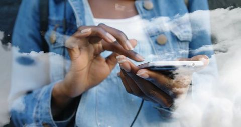Tapping Smartphone at Window with Cloud Reflection, Close-up Hands in Denim Jacket