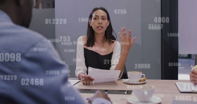 Businesswoman presenting ideas to her colleagues during a modern office meeting. Numbers overlaying the image represent data and analytics. Ideal for themes of business strategy, teamwork, leadership, data analytics, and modern collaborative work environments.