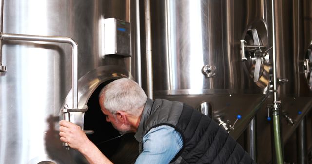 Brewery Worker Inspecting Stainless Steel Fermenter Tank - Download Free Stock Images Pikwizard.com