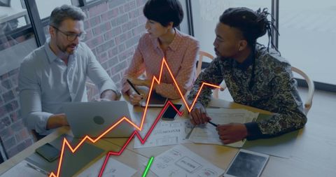 Diverse Team Analyzing Financial Graphs in Modern Office Setting