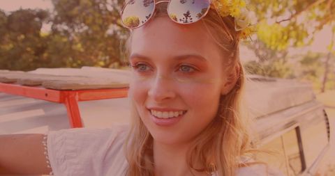 Smiling woman enjoying road trip with camper
