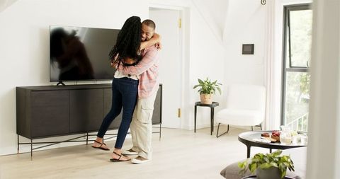 Happy Couple Celebrating Engagement in Modern Living Room