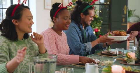 Diverse Friends Sharing Festive Holiday Meal with Turkey