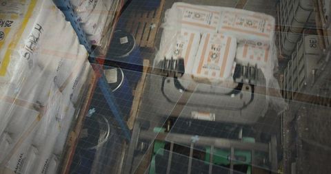 Transporting pallet of orange-labeled cartons on pallet jack through industrial aisle