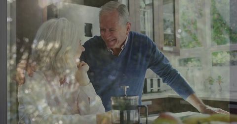 Mature Couple Enjoying Coffee Together in Sunlit Kitchen