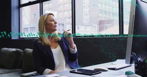 caucasian businesswoman sitting at desk, intently reviewing digital financial data visualizations displayed on computer. office window reveals urban cityscape suggesting corporate setting. suitable for illustrating finance and technology concepts, modern business practices, analytical thinking, and corporate environments in presentations or marketing materials.