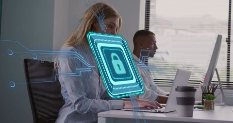 Woman Working on Laptop with Holographic Cybersecurity Lock Overlay in Modern Office