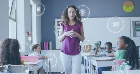 Elementary teacher leading interactive digital learning with students in modern classroom