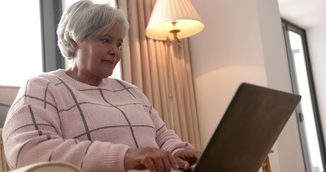 Senior Woman Engaging with Technology on Laptop at Home - Download Free Stock Images Pikwizard.com