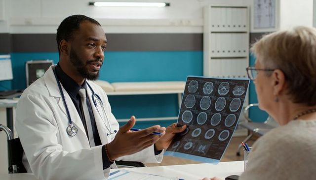 Doctor explaining brain mri and ct scans to senior patient during neurology consultation