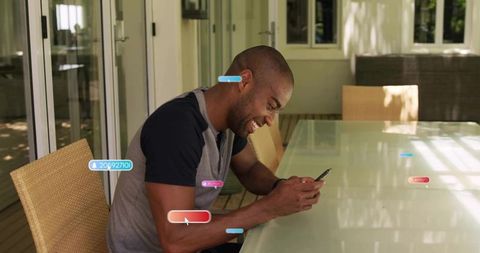 Man Enjoying Smartphone at Patio Table in Relaxing Outdoor Space