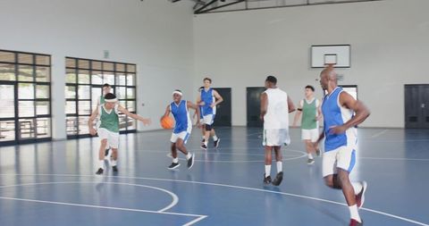 Diverse Basketball Players Competing in Indoor Gymnasium