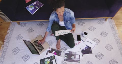 Businesswoman Analyzing Data with Laptop and Charts in Cozy Office