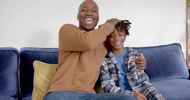 Father and son laughing and playing together on couch - Download Free Stock Images Pikwizard.com