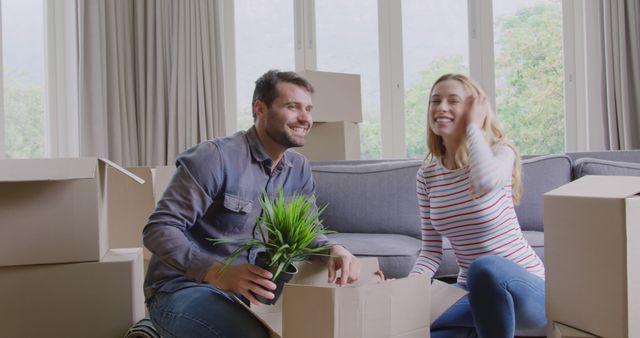 Happy caucasian couple unpacking cartons at new home - Download Free Stock Photos Pikwizard.com