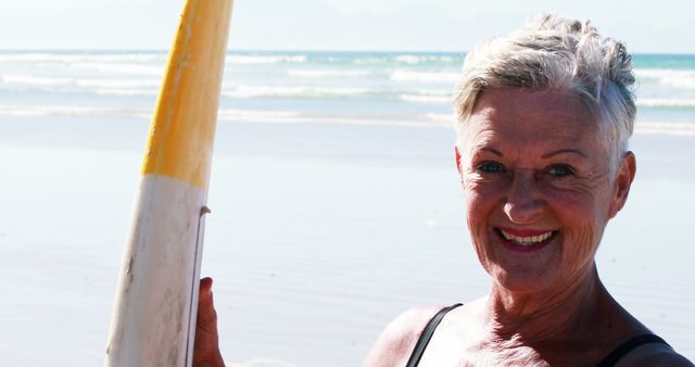 Senior Woman Surfing at Beach Smiling on a Sunny Day - Download Free Stock Images Pikwizard.com