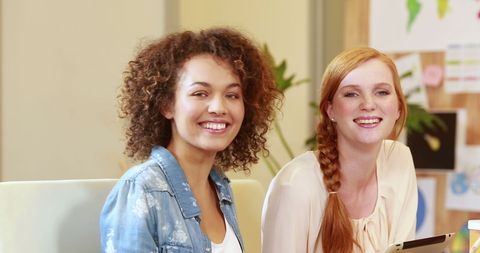 Two Diverse Women Collaborating in Office Environment
