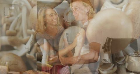 Couple embracing and smiling in cozy kitchen with mushroom double exposure overlay