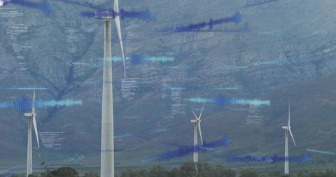 Wind turbines generating power with blue data overlays and waveform monitoring in foothills