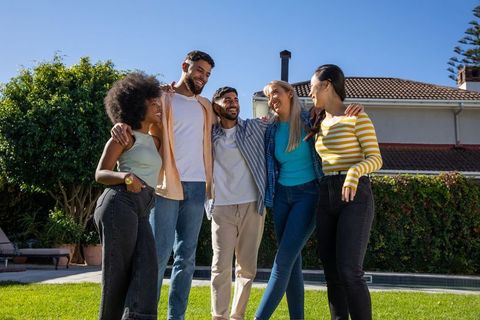 Diverse Friends Bonding Outdoors in Sunny Backyard