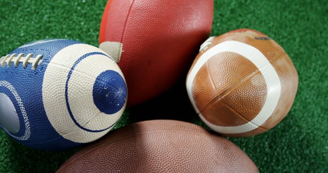 Assorted Footballs on Green Turf Surface - Download Free Stock Images Pikwizard.com