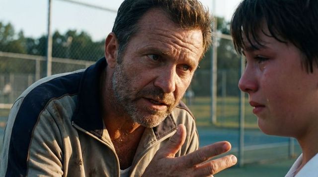 Emotional coaching moment: mentor comforting crying teen on tennis court