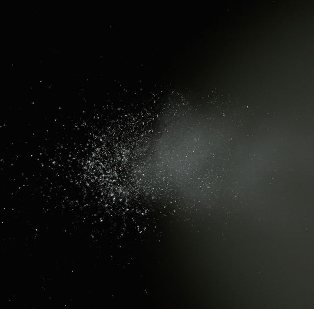 Fine particles of dust suspended in the air against dark background - Download Free Stock Images Pikwizard.com
