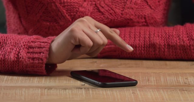 Person Using Smartphone Touchscreen with Sweater on Wooden Table - Download Free Stock Images Pikwizard.com