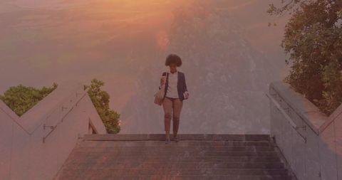Woman Reading Map on Staircase with Sunset Overlay